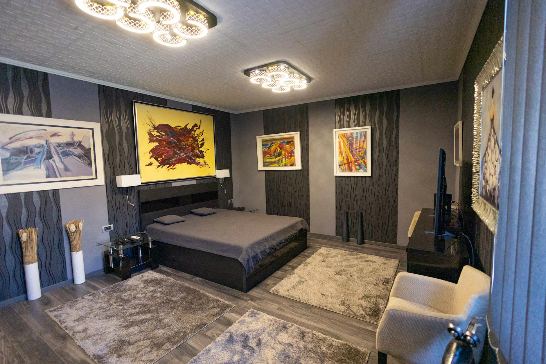 Nowoczesna sypialnia z abstrakcyjną galerią ścienną nad łóżkiem